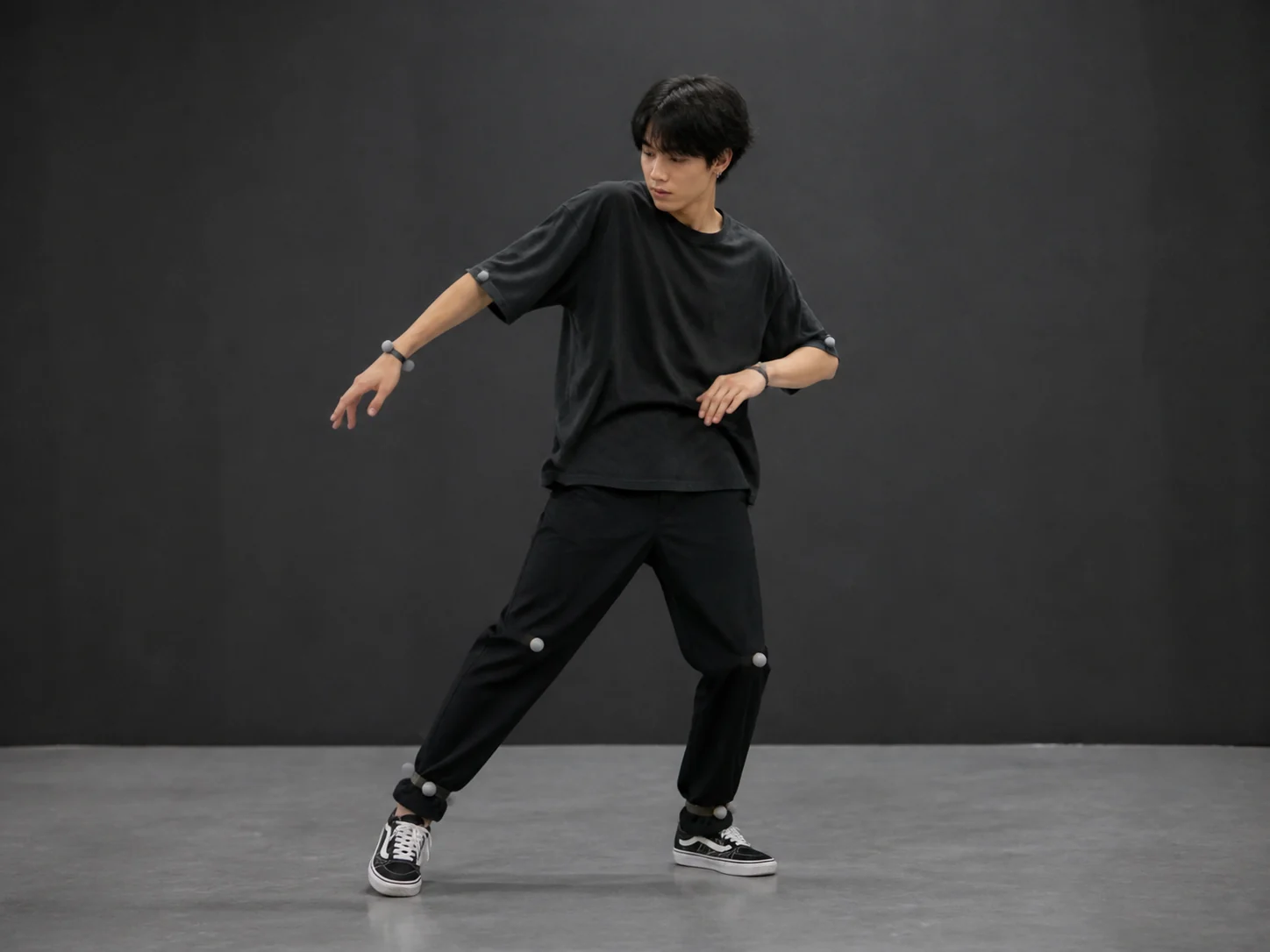 Full-body dancer with visible motion tracking points in a simple studio