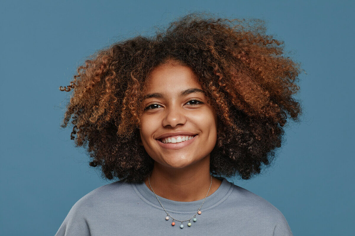 Portrait of a woman against a blue background before background removal