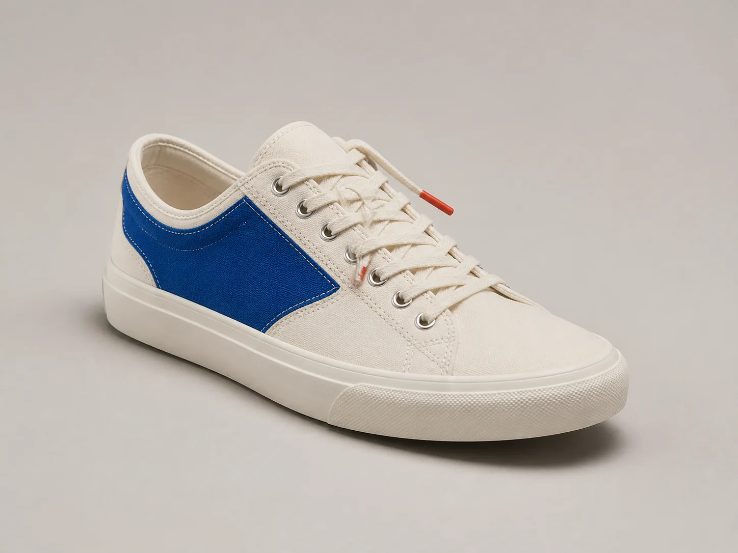 Studio photograph of a white and cobalt sneaker before Transform Style