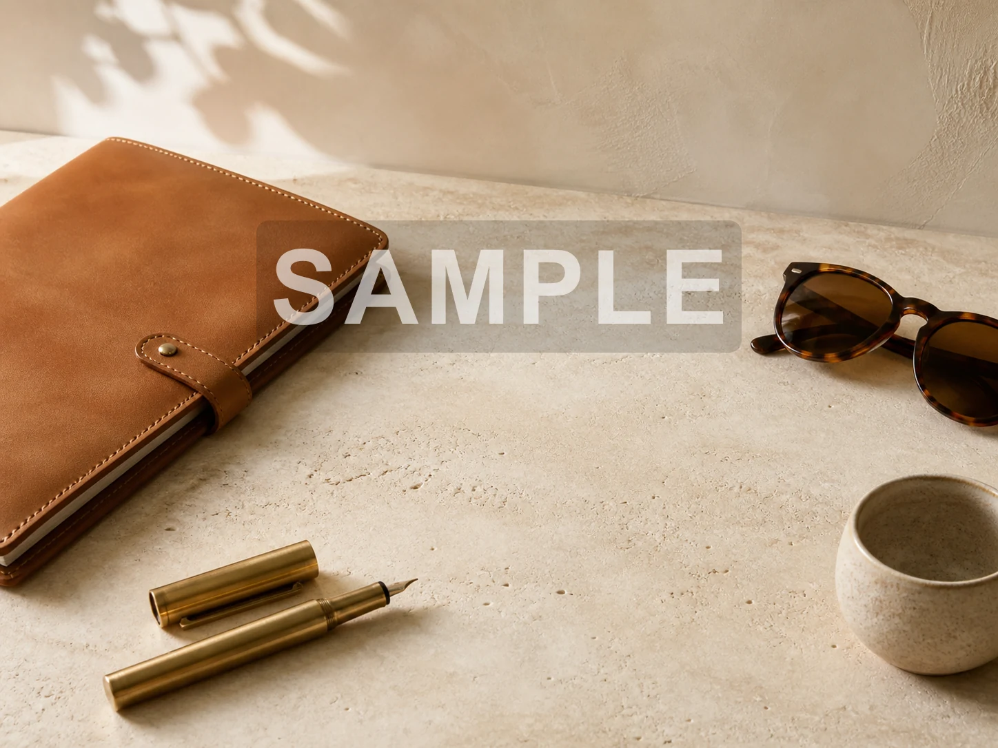Desk flat lay covered by a large SAMPLE overlay before Watermark Remover processing